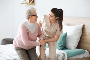 woman helping a senior with an individualized care plan