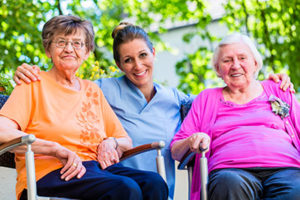 two women sitting with integrative assisted care worker 