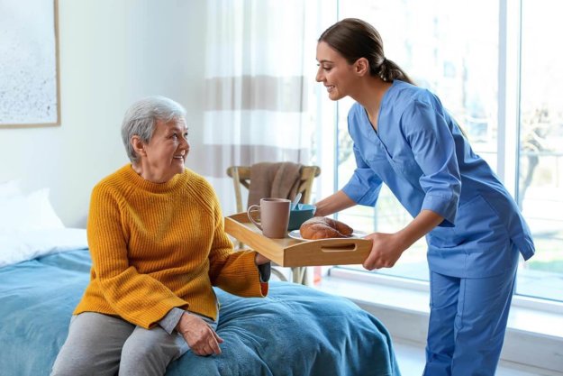 nurse helping a resident at an assisted care home